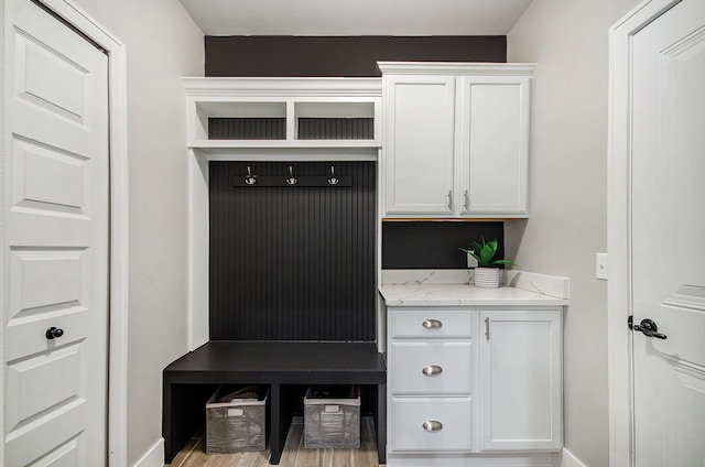 mudroom featuring baseboards and wood finished floors