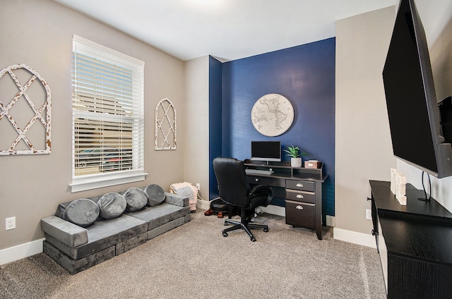 carpeted home office with baseboards