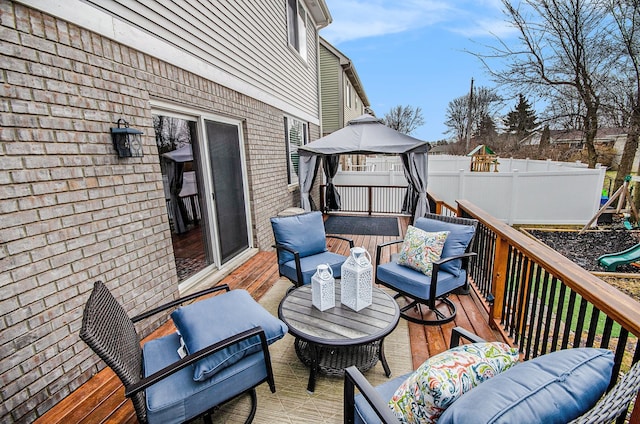 wooden terrace with fence and outdoor lounge area