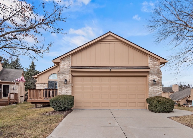 view of front of house with driveway, a garage, a deck, and brick siding