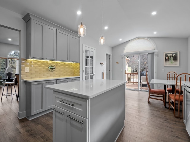 kitchen featuring light countertops, tasteful backsplash, dark wood-style flooring, and gray cabinetry