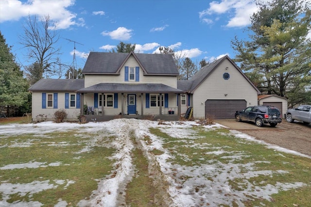 view of front of property with a porch, driveway, and an attached garage