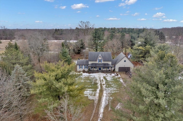 drone / aerial view with a wooded view