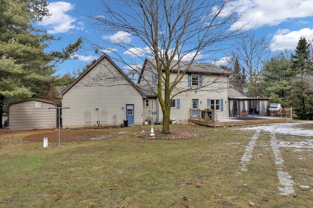 back of house with a yard, an outdoor structure, a storage shed, driveway, and a wooden deck