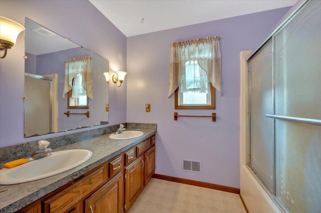 full bathroom featuring visible vents, a sink, baseboards, and double vanity