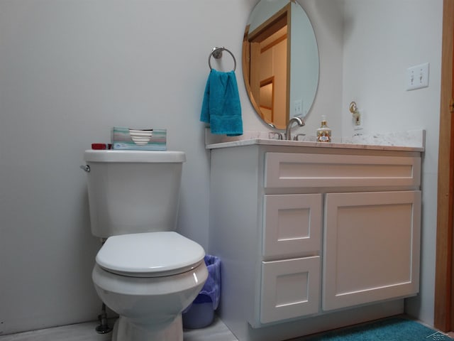 bathroom featuring toilet and vanity