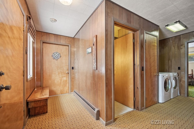 hallway featuring wood walls, independent washer and dryer, and a baseboard radiator