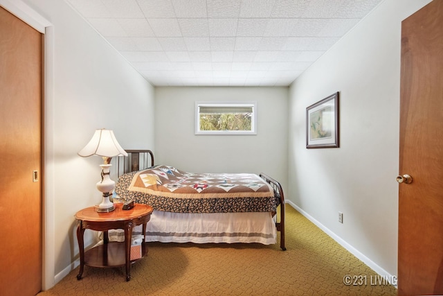 bedroom featuring carpet flooring and baseboards