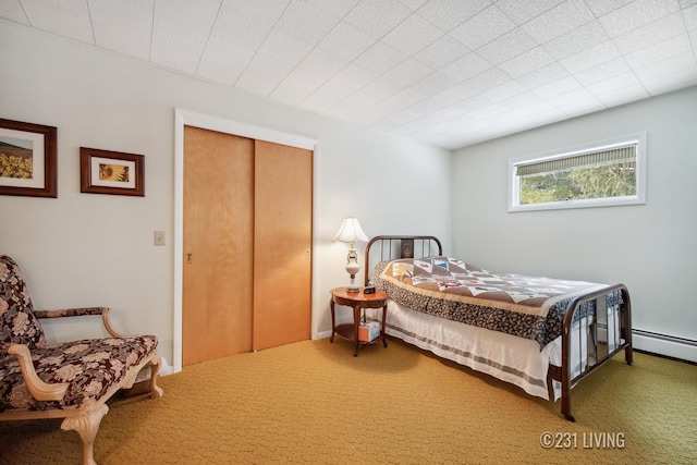 bedroom featuring carpet floors, a baseboard radiator, and a closet