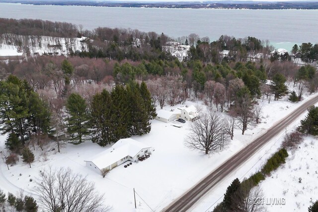 snowy aerial view featuring a water view