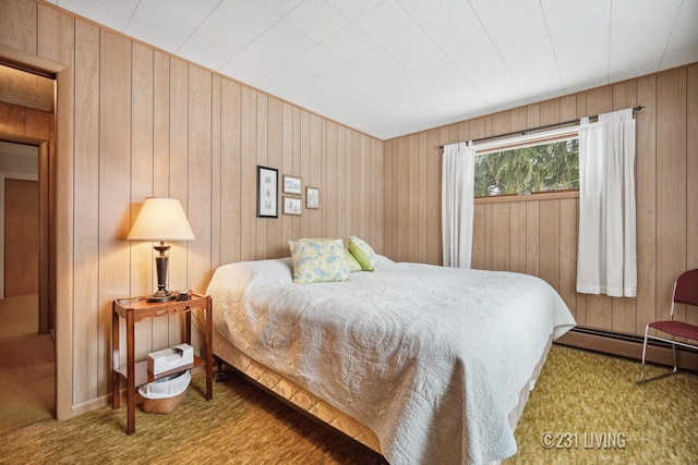 bedroom featuring carpet floors, wood walls, and baseboard heating