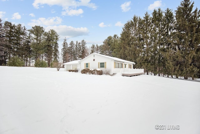 view of front of home with an attached garage and a wooden deck