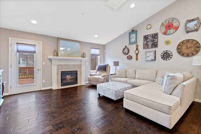 living area with dark wood-style floors, baseboards, a fireplace, recessed lighting, and vaulted ceiling