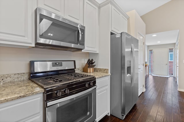 kitchen with appliances with stainless steel finishes, dark wood finished floors, and white cabinetry