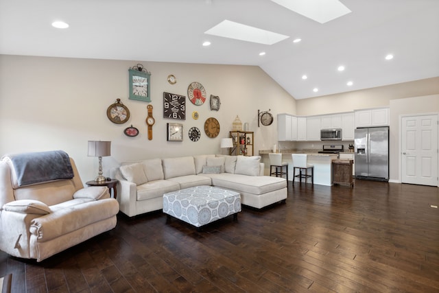 living area featuring dark wood-style floors, high vaulted ceiling, recessed lighting, and a skylight