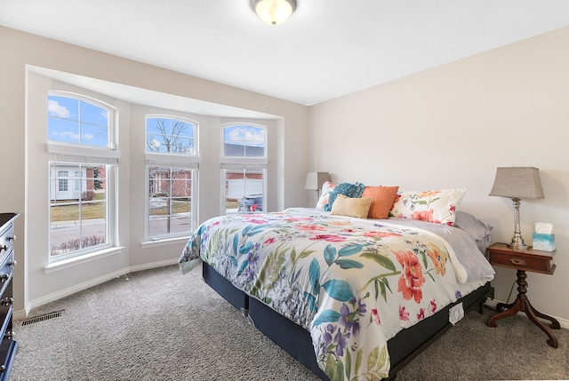 carpeted bedroom featuring visible vents and baseboards