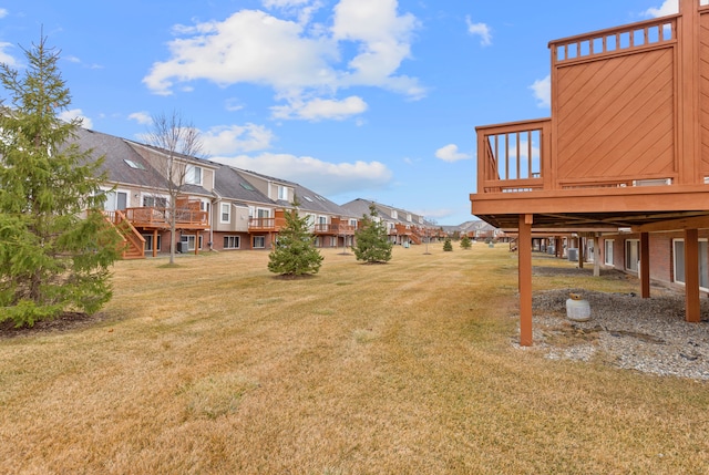 view of yard with a wooden deck and a residential view