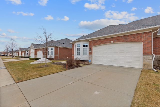 view of front of house with brick siding, stone siding, a front yard, and driveway