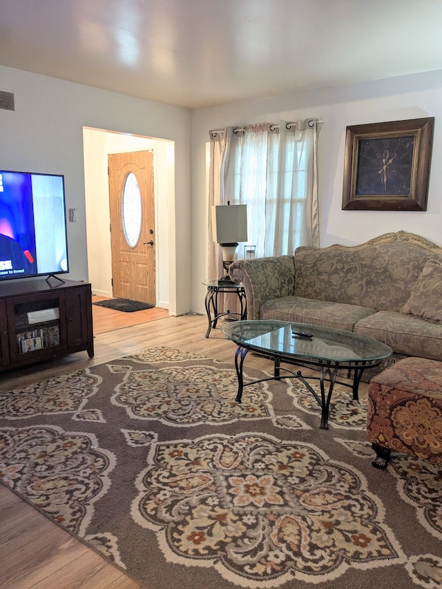 living room with visible vents and wood finished floors