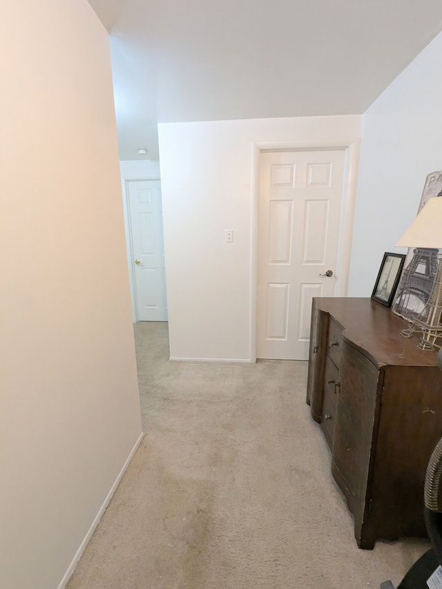 corridor with light carpet and baseboards