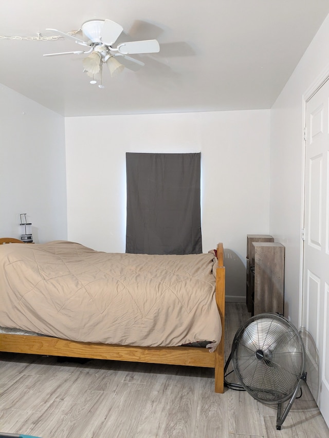 bedroom featuring ceiling fan and wood finished floors