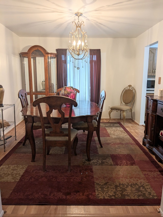 dining room with a chandelier and wood finished floors