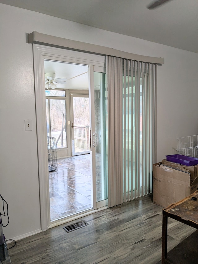 entryway featuring a ceiling fan, visible vents, and wood finished floors