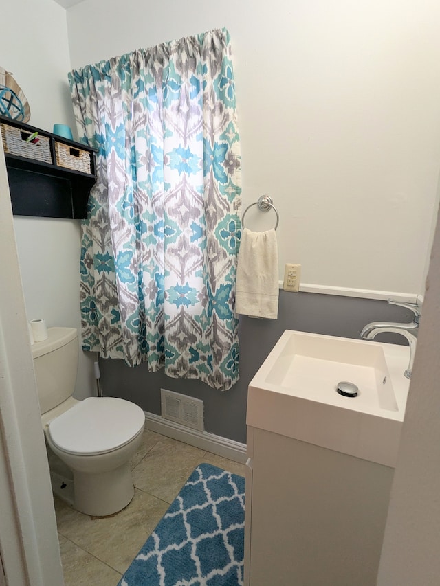 bathroom featuring tile patterned flooring, visible vents, vanity, and toilet