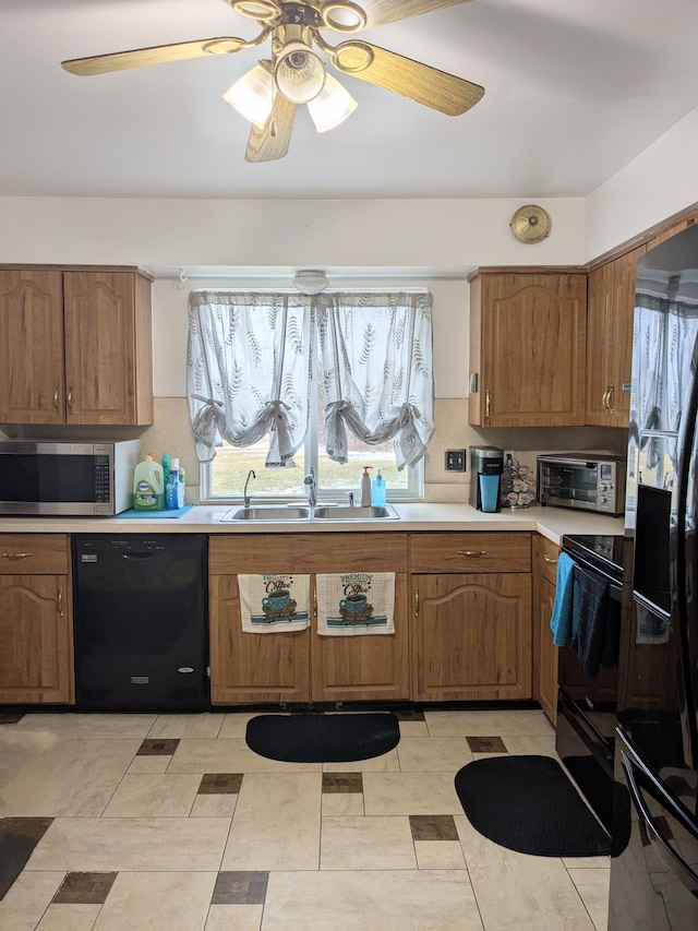 kitchen featuring light countertops, backsplash, brown cabinetry, a sink, and black appliances