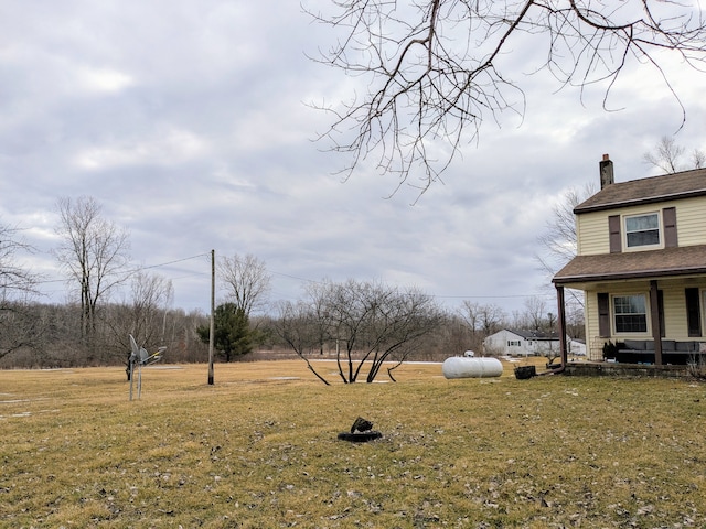 view of yard featuring covered porch