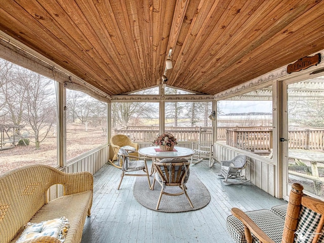 sunroom / solarium featuring vaulted ceiling and wooden ceiling