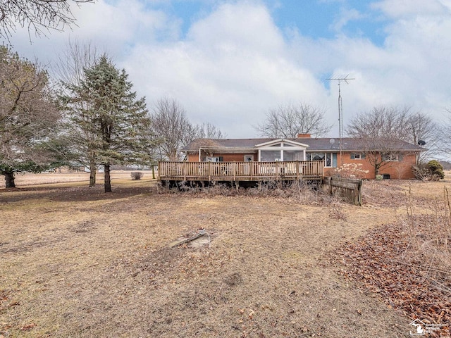 rear view of house featuring a deck