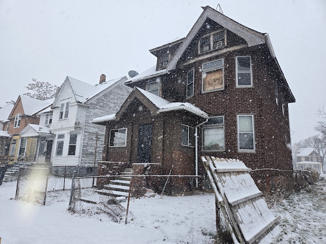 view of front of home featuring a fenced front yard and brick siding