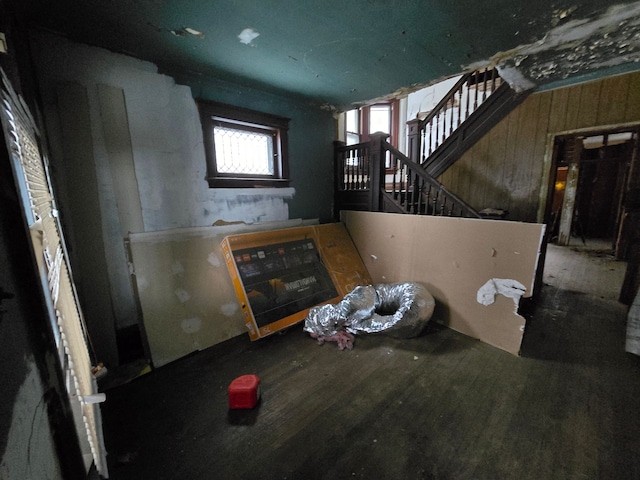 unfurnished living room featuring stairs