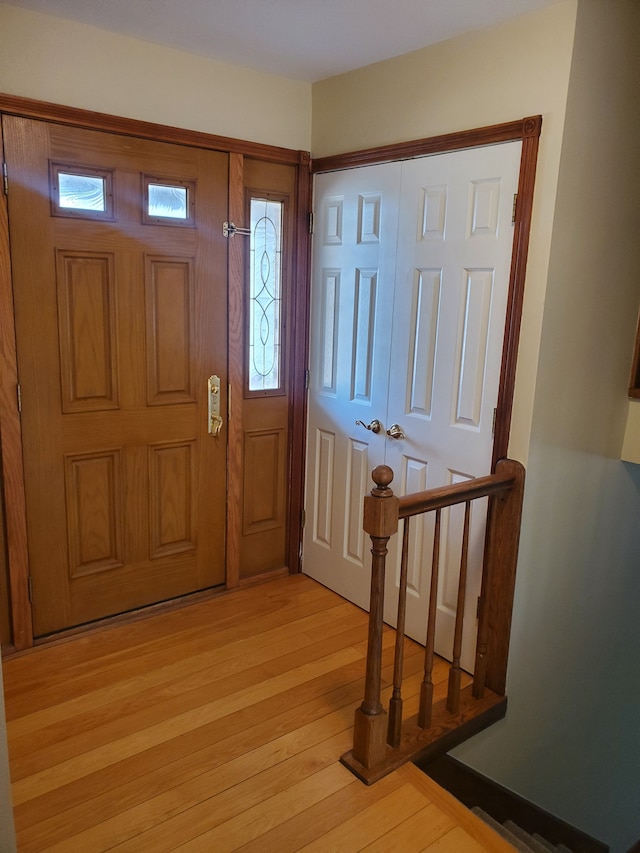 foyer entrance with light wood finished floors