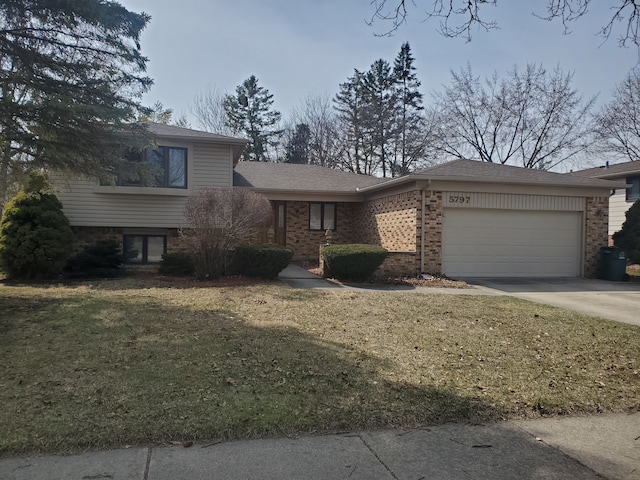 split level home with an attached garage, brick siding, concrete driveway, and a front yard