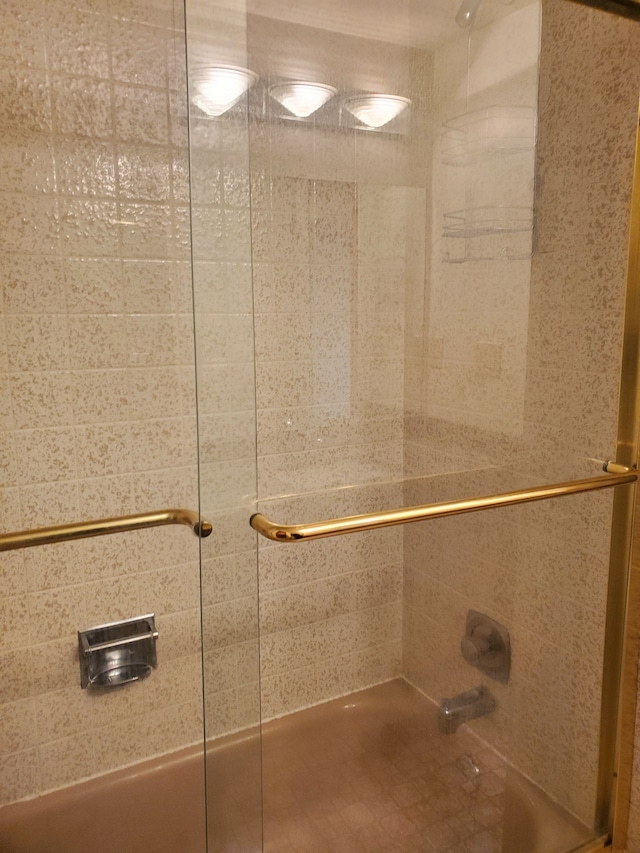 room details featuring combined bath / shower with glass door