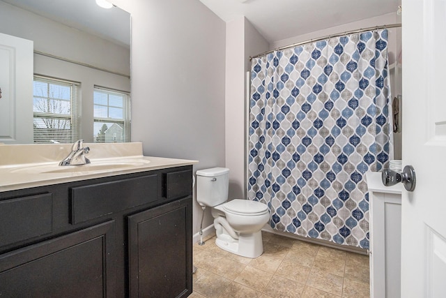 bathroom featuring curtained shower, toilet, vanity, baseboards, and tile patterned floors