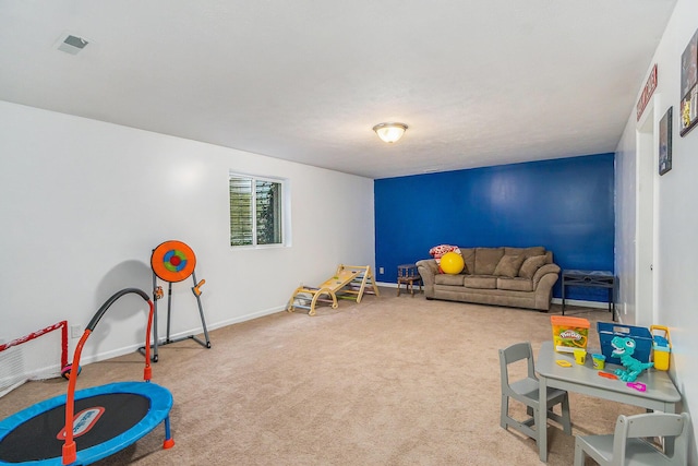 recreation room with carpet floors, visible vents, and baseboards