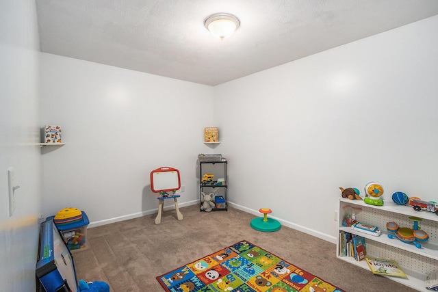 recreation room featuring carpet and baseboards