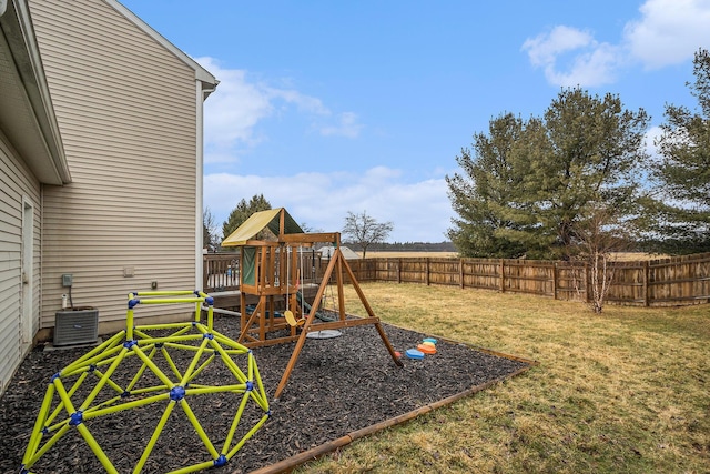 view of yard featuring central AC, a playground, and fence