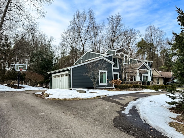 view of front of property with aphalt driveway and an attached garage