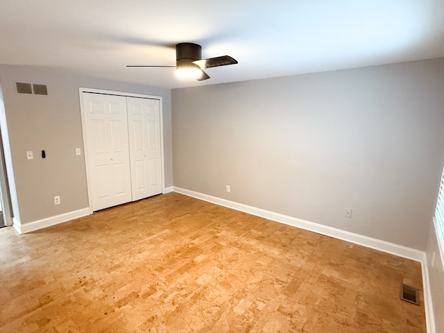 unfurnished bedroom featuring baseboards, visible vents, and a closet