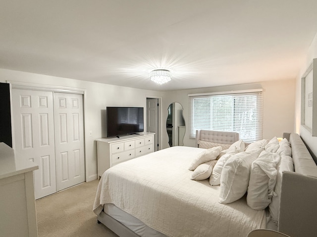 bedroom featuring a closet and light carpet