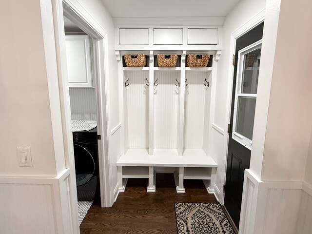 mudroom featuring a wainscoted wall, washer / clothes dryer, dark wood-type flooring, and a decorative wall