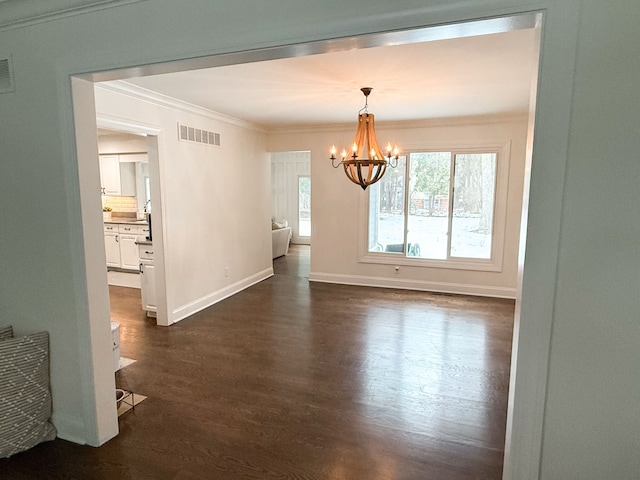 unfurnished dining area featuring visible vents, crown molding, baseboards, a notable chandelier, and dark wood-style flooring