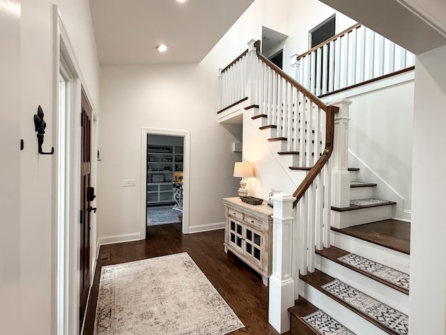 foyer with recessed lighting, wood finished floors, and baseboards