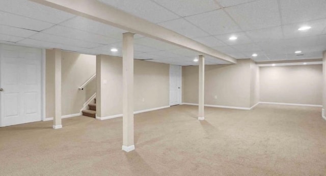 finished below grade area with stairs, recessed lighting, baseboards, and carpet floors