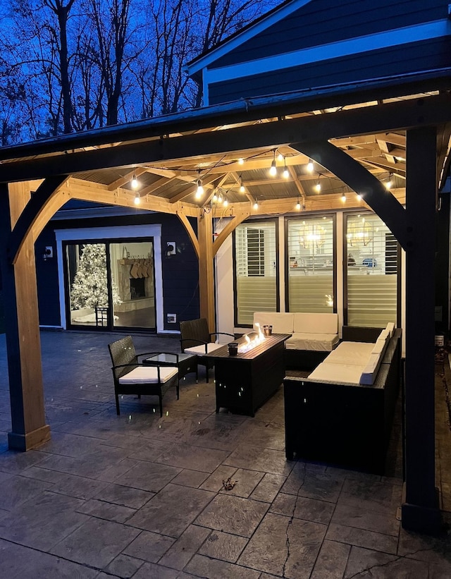 view of patio / terrace with an outdoor living space with a fire pit