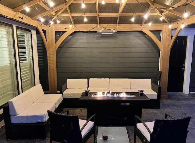 view of patio with an outdoor living space with a fire pit